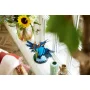 LEGO-Eisvogel mit blauen und orangefarbenen Federn auf einem Sockel, auf einer Fensterbank neben Blumen platziert LEGO-Eisvogel mit blauen und orangefarbenen Federn auf einem Sockel, auf einer Fensterbank neben Blumen platziert