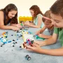 Quatre enfants construisent ensemble sur un tapis avec des briques LEGO colorées, boîte de rangement jaune visible en arrière-plan Quatre enfants construisent ensemble sur un tapis avec des briques LEGO colorées, boîte de rangement jaune visible en arrière-plan