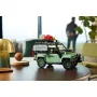Land Rover Defender 90 LEGO vert menthe avec équipements sur le toit, posé sur une table ronde dans un salon moderne Land Rover Defender 90 LEGO vert menthe avec équipements sur le toit, posé sur une table ronde dans un salon moderne