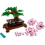 LEGO Bonsai with green foliage on brown base, accompanied by detached pink branches and turquoise brick separator tool LEGO Bonsai with green foliage on brown base, accompanied by detached pink branches and turquoise brick separator tool