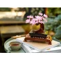 LEGO bonsai tree with pink cherry blossoms on wooden stand, placed on books next to a tea cup LEGO bonsai tree with pink cherry blossoms on wooden stand, placed on books next to a tea cup
