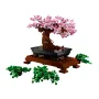 LEGO Bonsai tree with pink flowers on black tray and brown base, loose green foliage pieces visible LEGO Bonsai tree with pink flowers on black tray and brown base, loose green foliage pieces visible