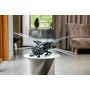 LEGO Atreides Royal Ornithopter displayed on white round table in modern living room, featuring extended wings and detailed cockpit