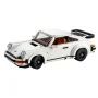 White LEGO Porsche 911 with rear spoiler, round headlights, brown interior and black rims on white background