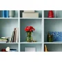 LEGO red rose bouquet in green glass vase on white shelf surrounded by books and decorative objects