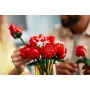 LEGO red roses bouquet in golden vase with white baby's breath flowers, held by hands